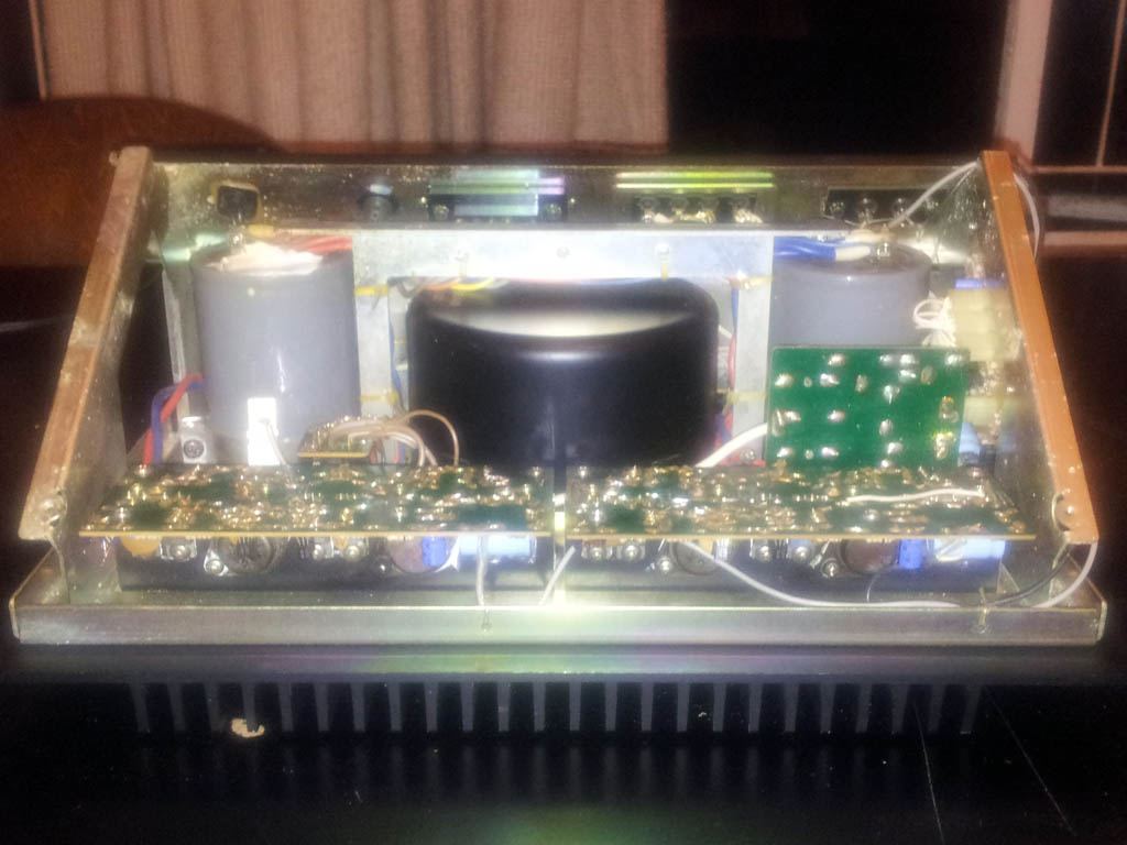 Inside a Nakamichi 620 power amplifier, showing the large transformer and circuit boards through a clear cover