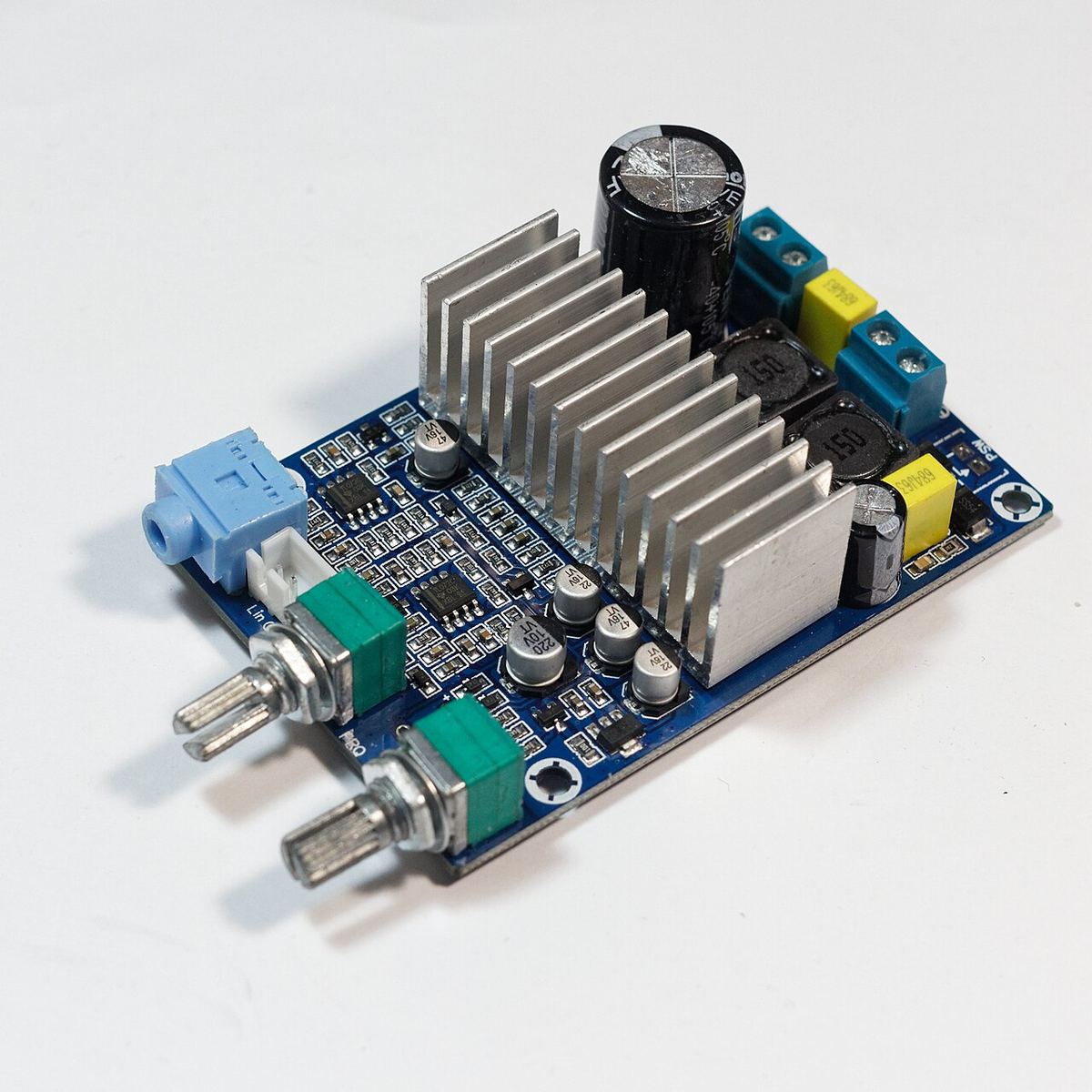 Small Class D amplifier module built around a TPA3116 chip, with a compact heatsink