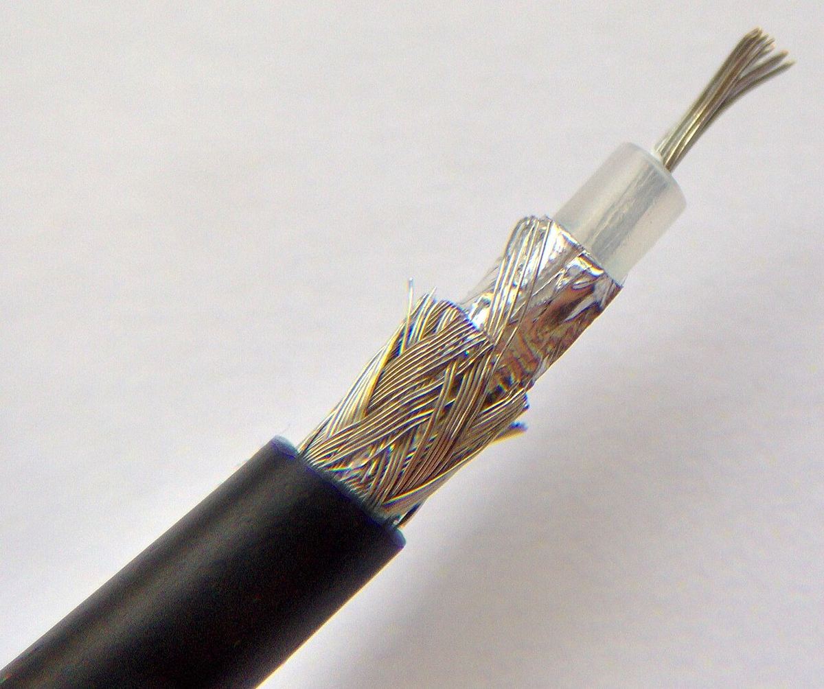 Cut-away coaxial cable showing the centre conductor, white dielectric, foil and braided shield layers