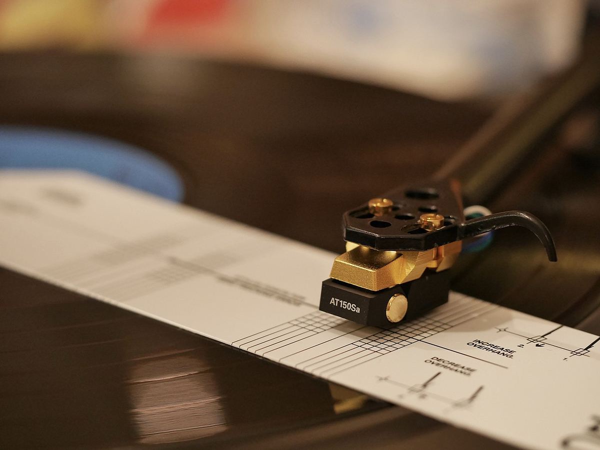 Audio-Technica cartridge sitting on a printed alignment protractor on the platter