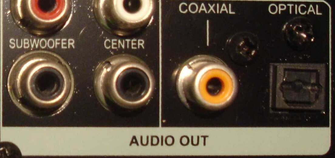 Rear panel of a DVD player with an orange coaxial digital output and a square optical output