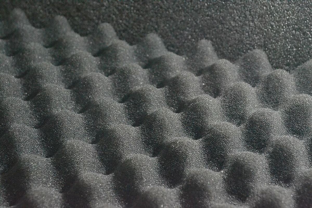 Close-up of grey acoustic foam with an egg-crate profile