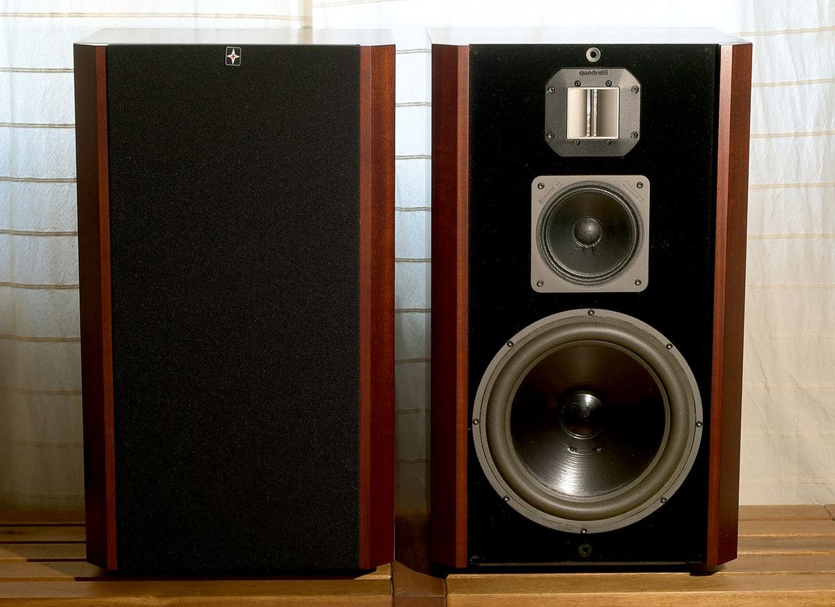 Pair of Quadral Shogun three-way loudspeakers, one with its grille removed showing woofer, midrange and tweeter