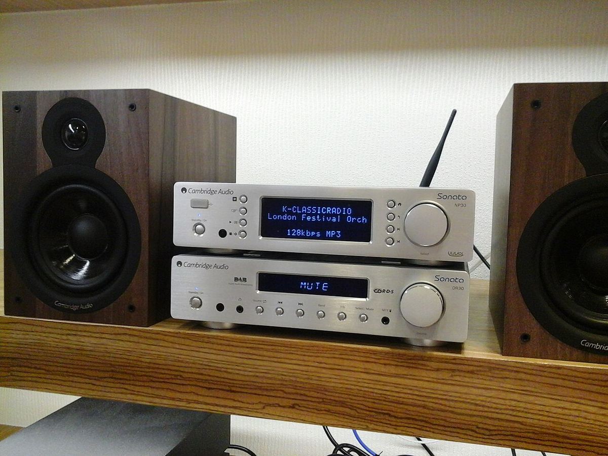 Cambridge Audio NP30 network player stacked on a receiver between bookshelf speakers