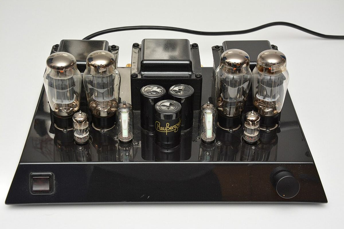 Tube power amplifier with exposed output valves and transformers on a black chassis